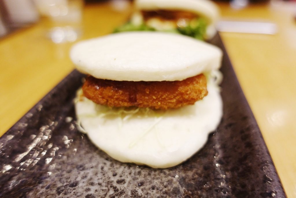 Steamed bun with fried shrimp patty, shredded cabbage, and Japanese mayo