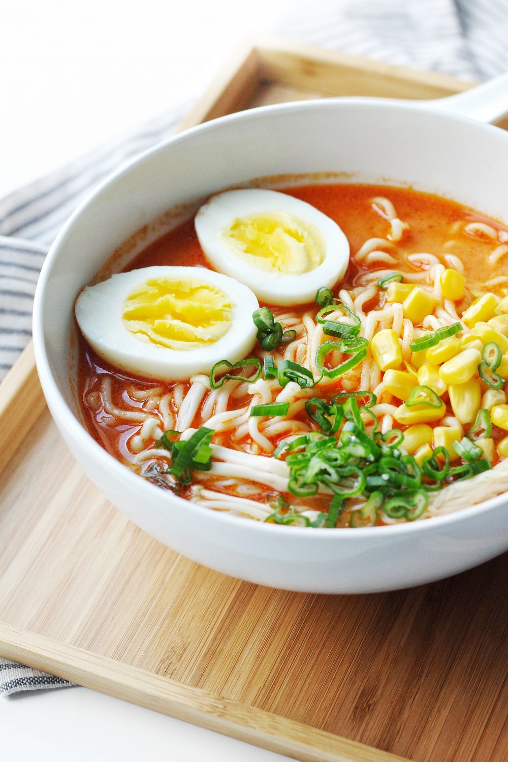 Sideview of a bowl of easy sriracha ramen.