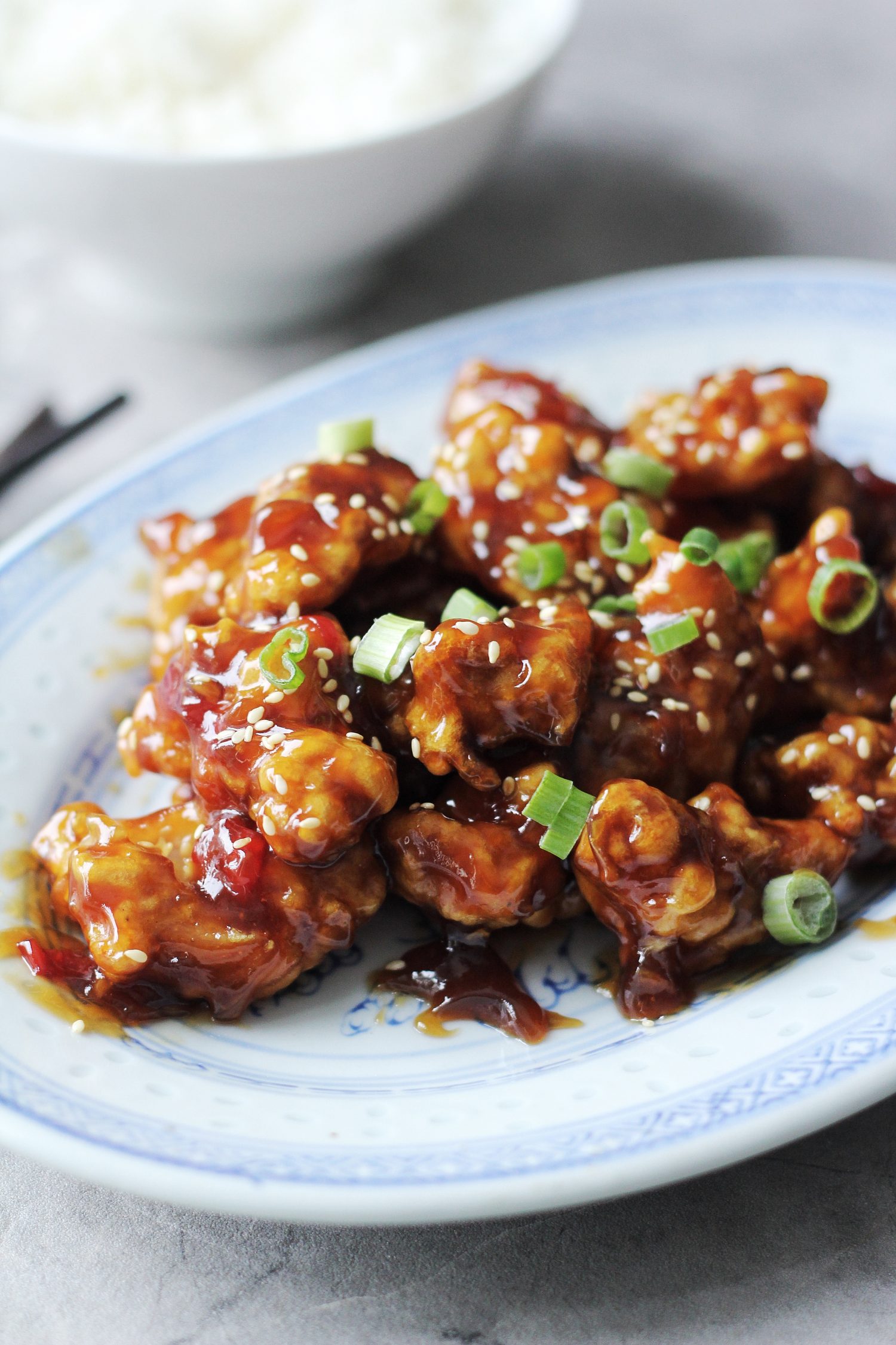 Blue Chinese plate topped with general tso's chicken.