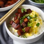 Bowl of spam and eggs topped on steamed white rice.