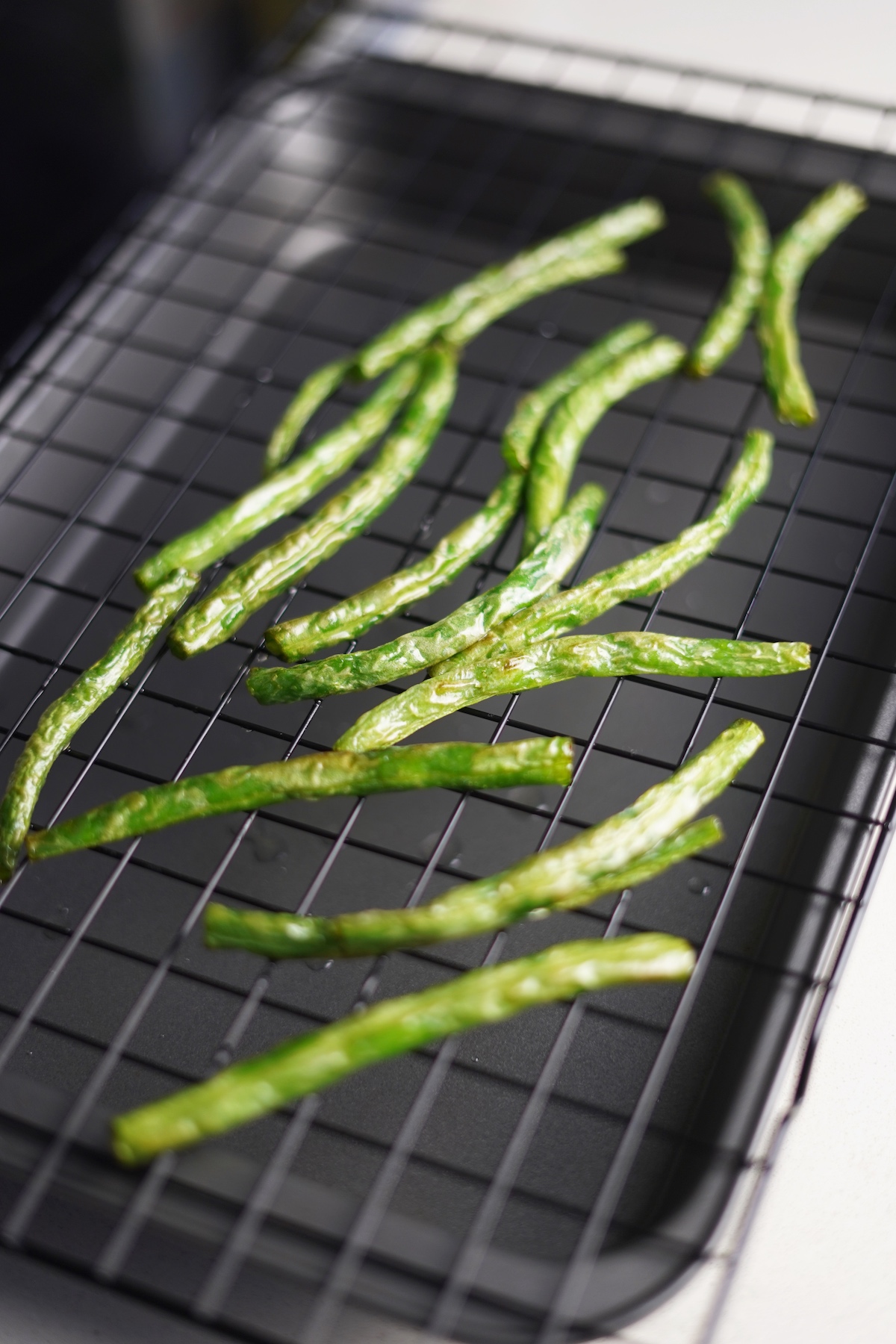 Green beans on a drying rack.