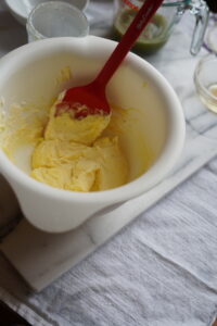 Mascarpone in a bowl, folded with egg yolk mixture.