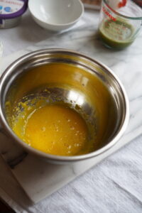 Bowl of egg yolk with sugar.