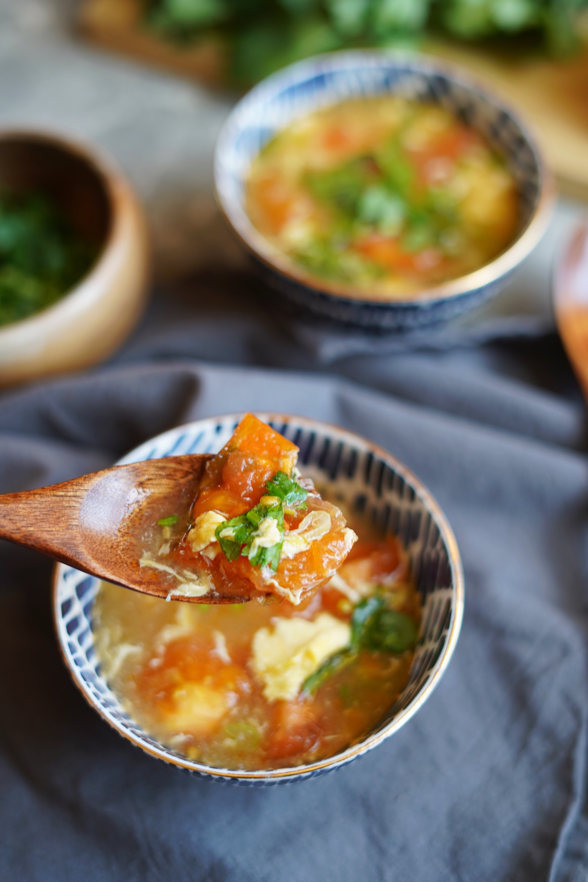 A spoonful of tomato egg drop soup.