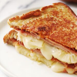 Close-up of Hawaiian pineapple and ham grilled cheese.