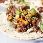 Close-up of Korean-style spicy beef tacos.