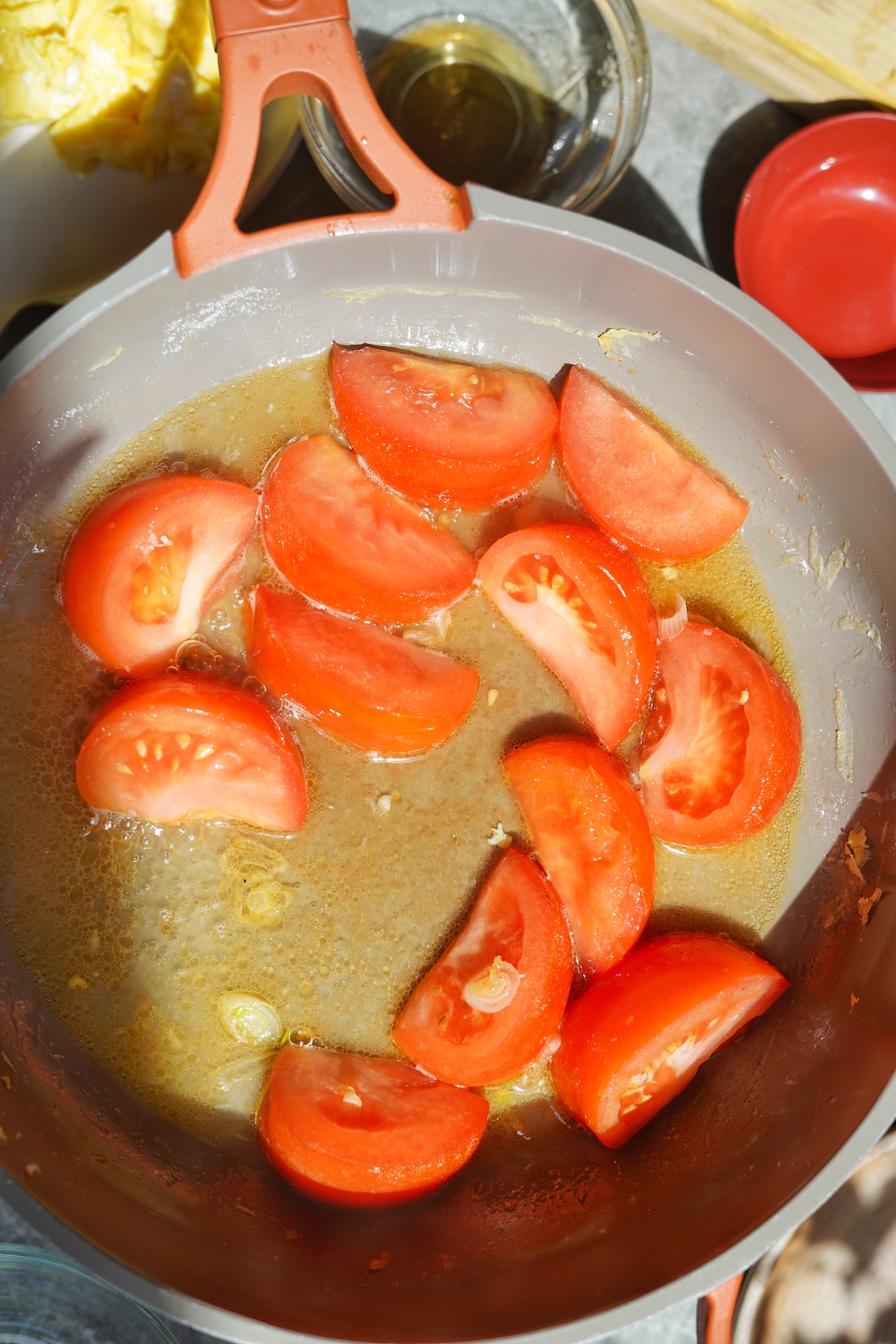 Tomatoes cooking in the seasoning.