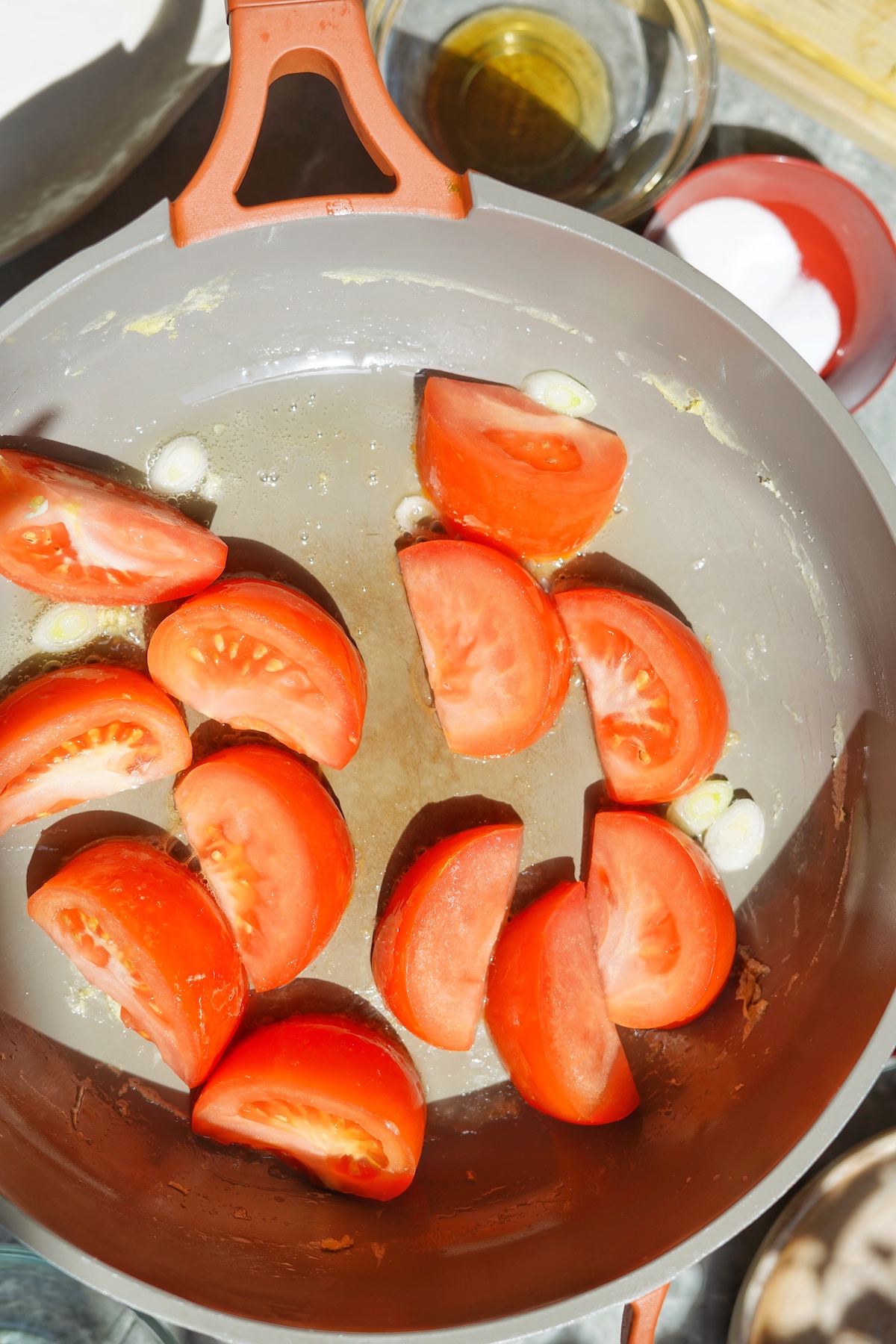 Tomatoes cooking in the large pan.