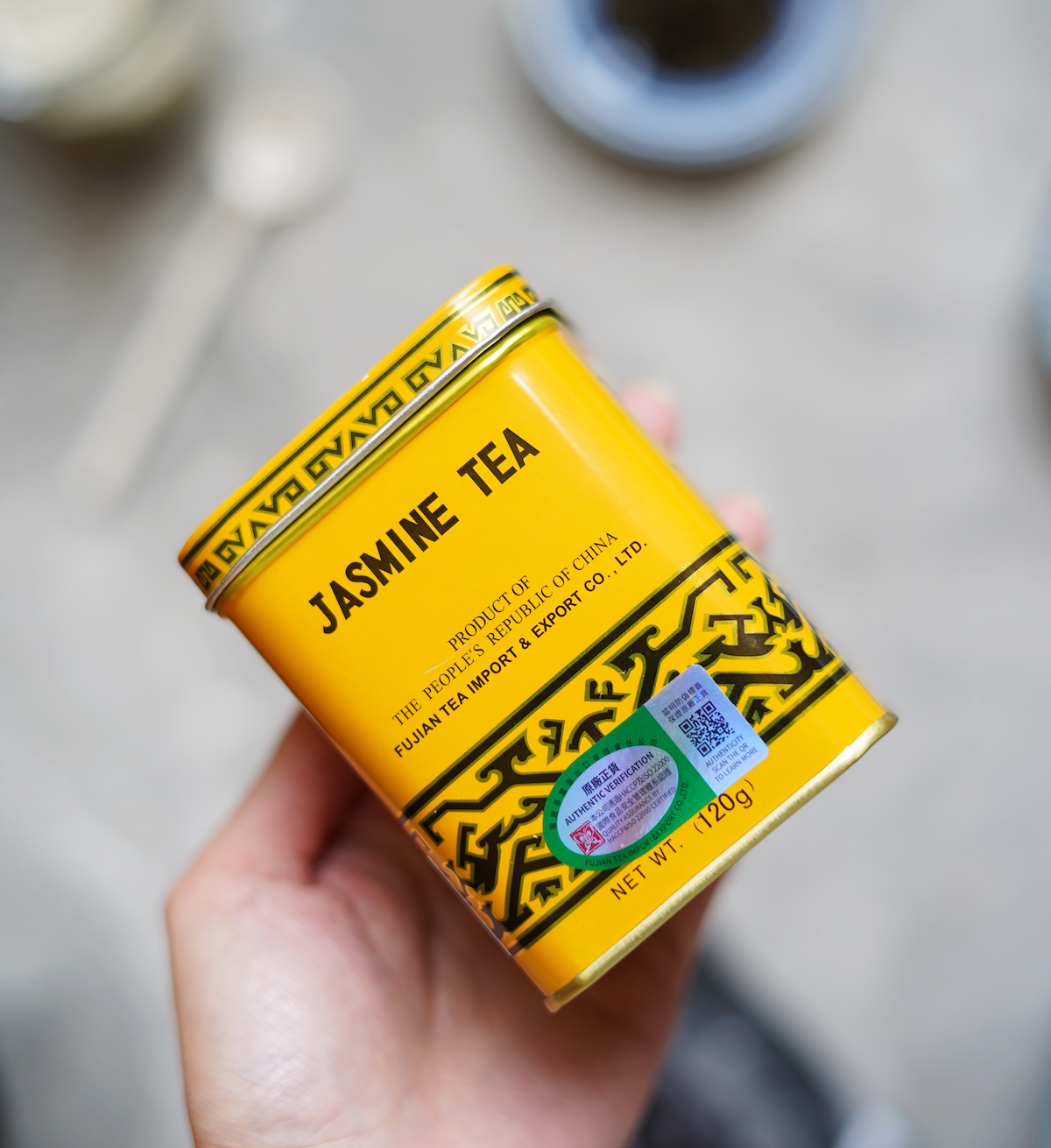 Tin box of jasmine tea leaves.